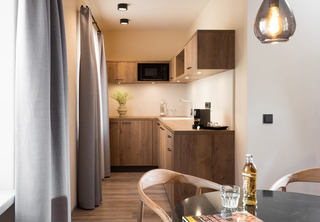 Fully equipped kitchen in a one-bedroom apartment at master Linzergasse, offering modern appliances and a functional layout.