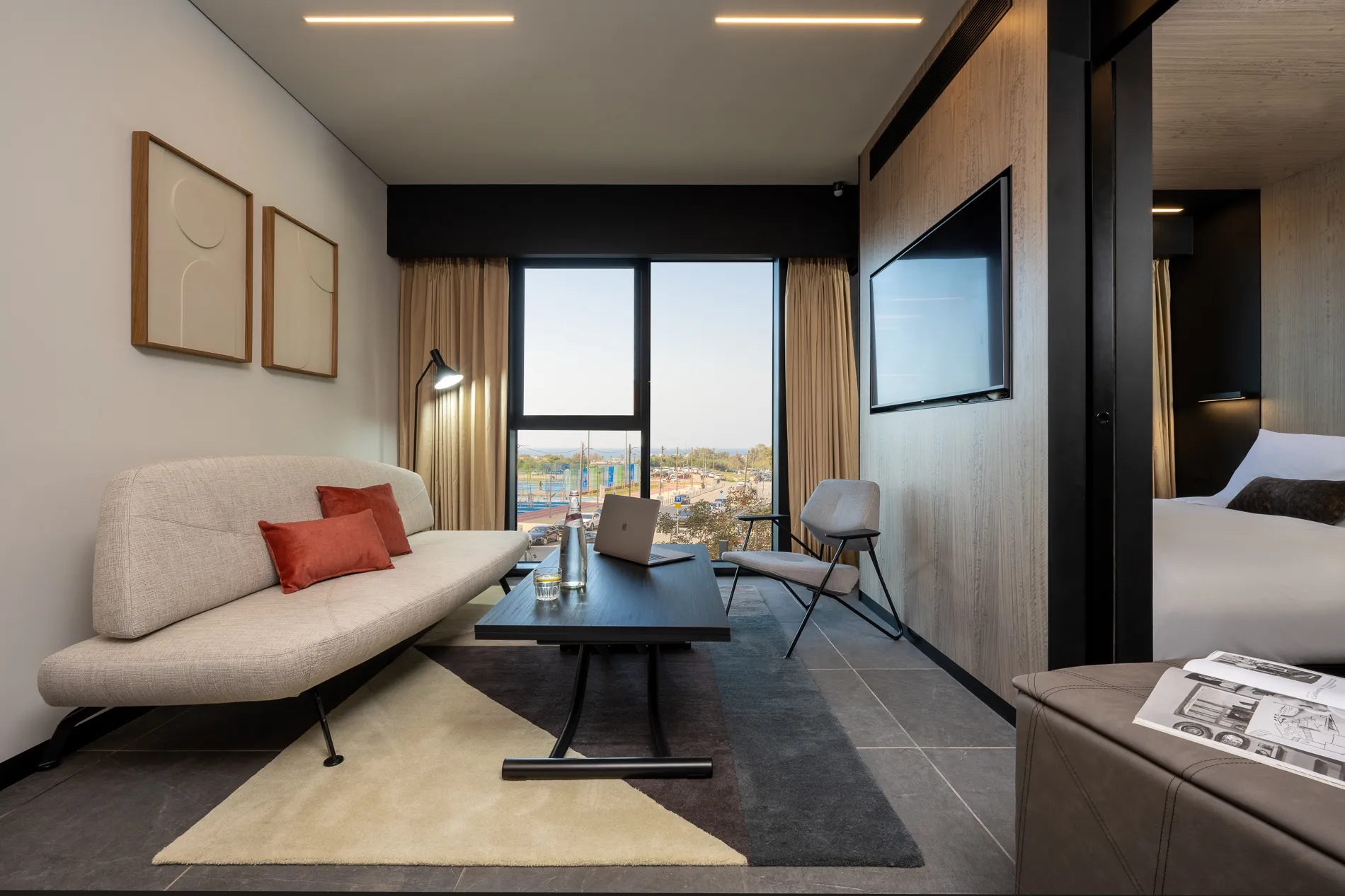 Well-appointed living space in the One-Bedroom Suite with Sofa Bed at master Bat Yam, blending a cozy seating area with contemporary furnishings