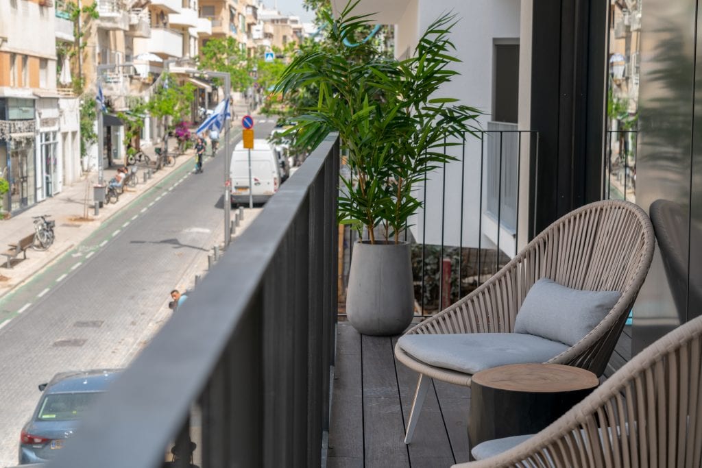 Well-designed balcony in the Three-Bedroom Apartment at master Shenkin Tel Aviv, seamlessly extending the living space outdoors