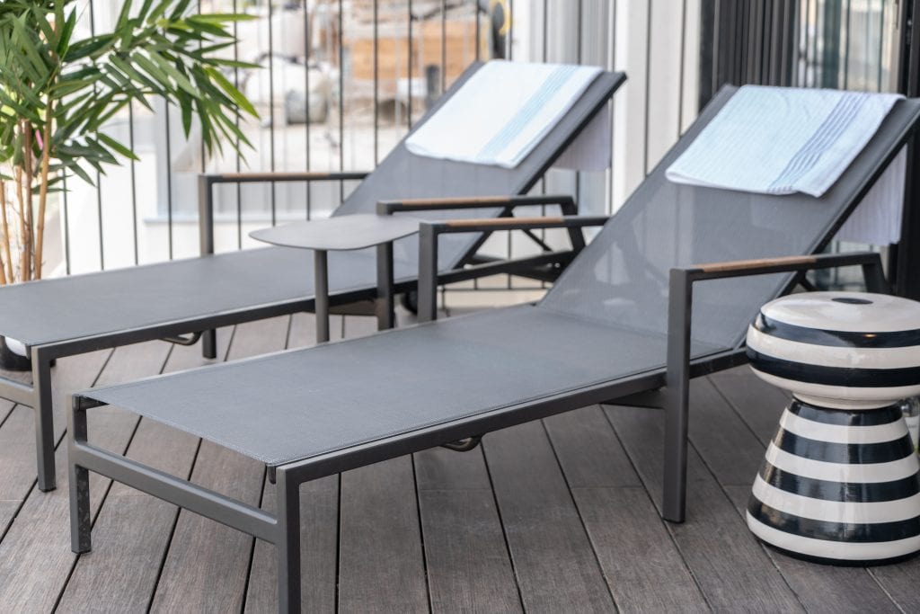 Sunbeds on the private terrace of the Three-Bedroom Apartment at master Shenkin Tel Aviv, perfect for soaking up the sun and enjoying the fresh air.