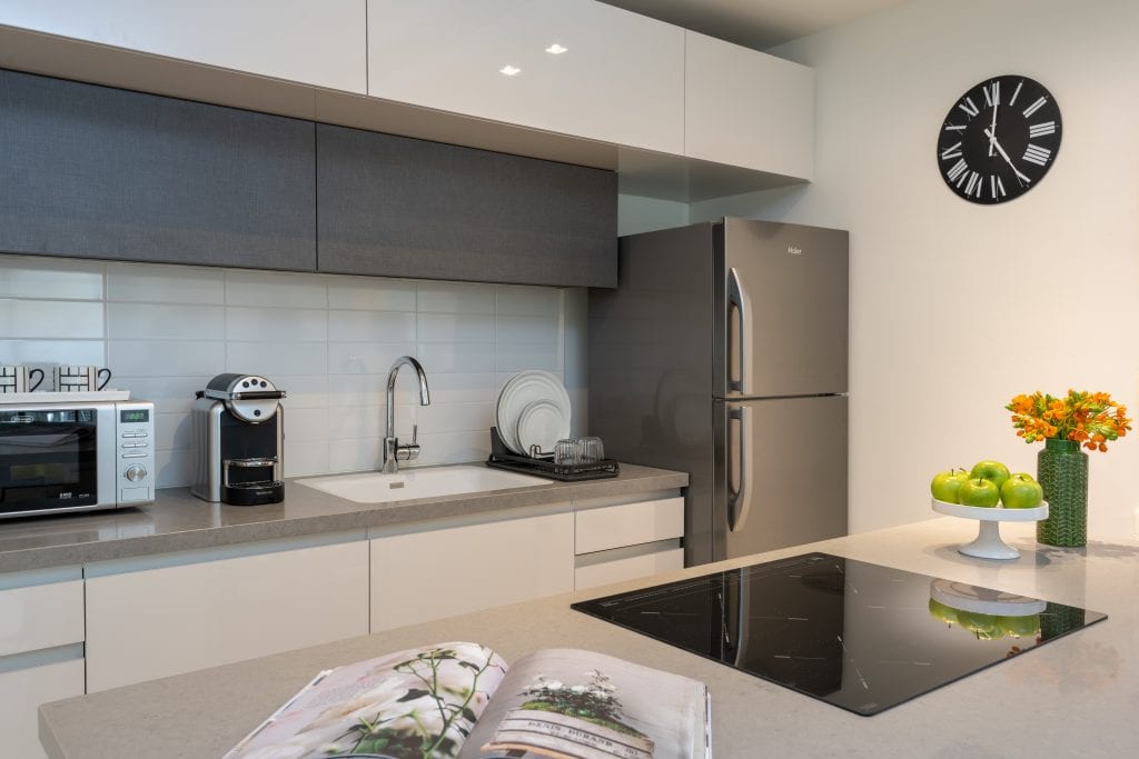 Well-equipped kitchen in the One-Bedroom Apartment with Balcony at master Shenkin Tel Aviv, featuring sleek cabinetry and modern appliances.