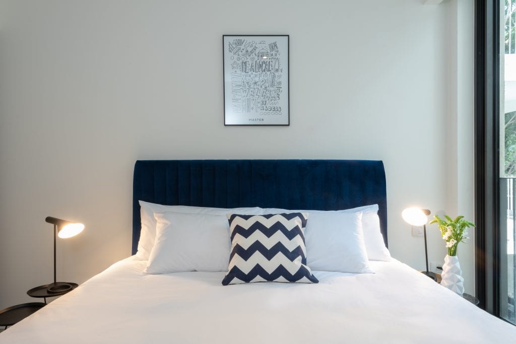 Comfortable bedroom in the One-Bedroom Apartment with Balcony at master Shenkin Tel Aviv, featuring a plush bed and warm lighting for a relaxing stay.