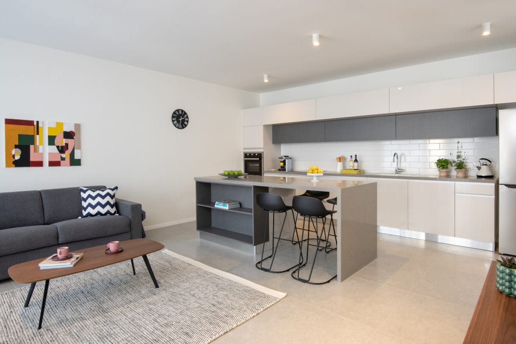 Compact and functional kitchenette in the Three-Bedroom Apartment at master Shenkin Tel Aviv, designed with sleek cabinetry and modern appliances