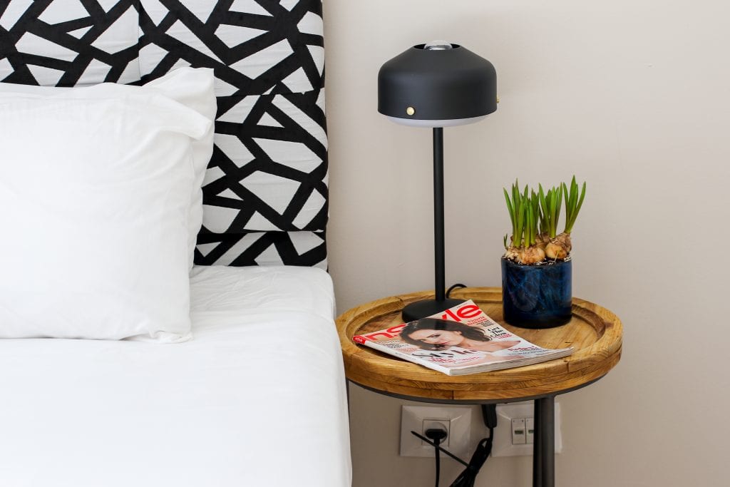 Comfortable bed at master Haifa, designed for a restful stay with soft linens and a warm, inviting ambiance.