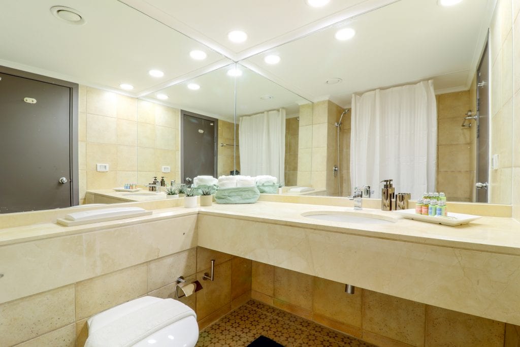 Simple and functional bathroom in the Studio Sea View Apartment at master Haifa, featuring a classic design with essential amenities.