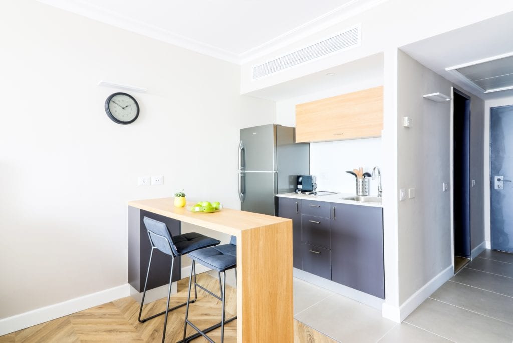 Sleek kitchenette at master Haifa, equipped with modern appliances and a contemporary design for a convenient stay.