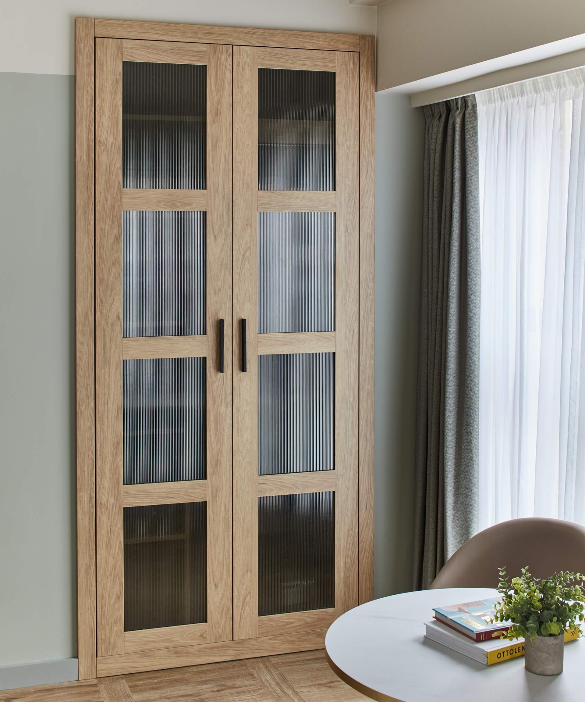Compact yet stylish dining area in the Studio at master St. Paul’s London, showcasing a table, two chairs, and a closed closet for storage.