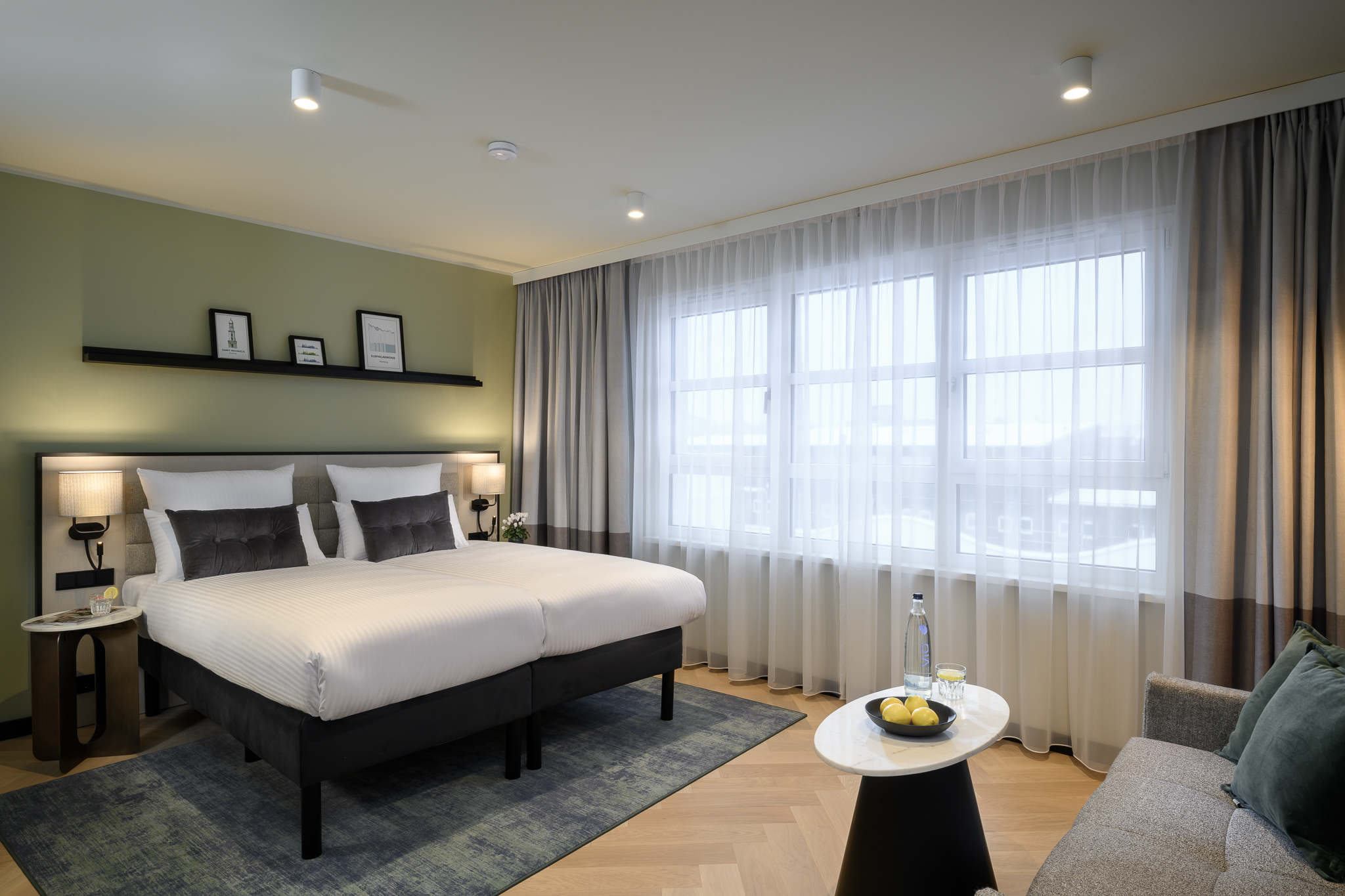 Bright and cozy sleeping area in the Studio with Sofa Bed at master Altona Hamburg, featuring a comfortable bed next to a large window.