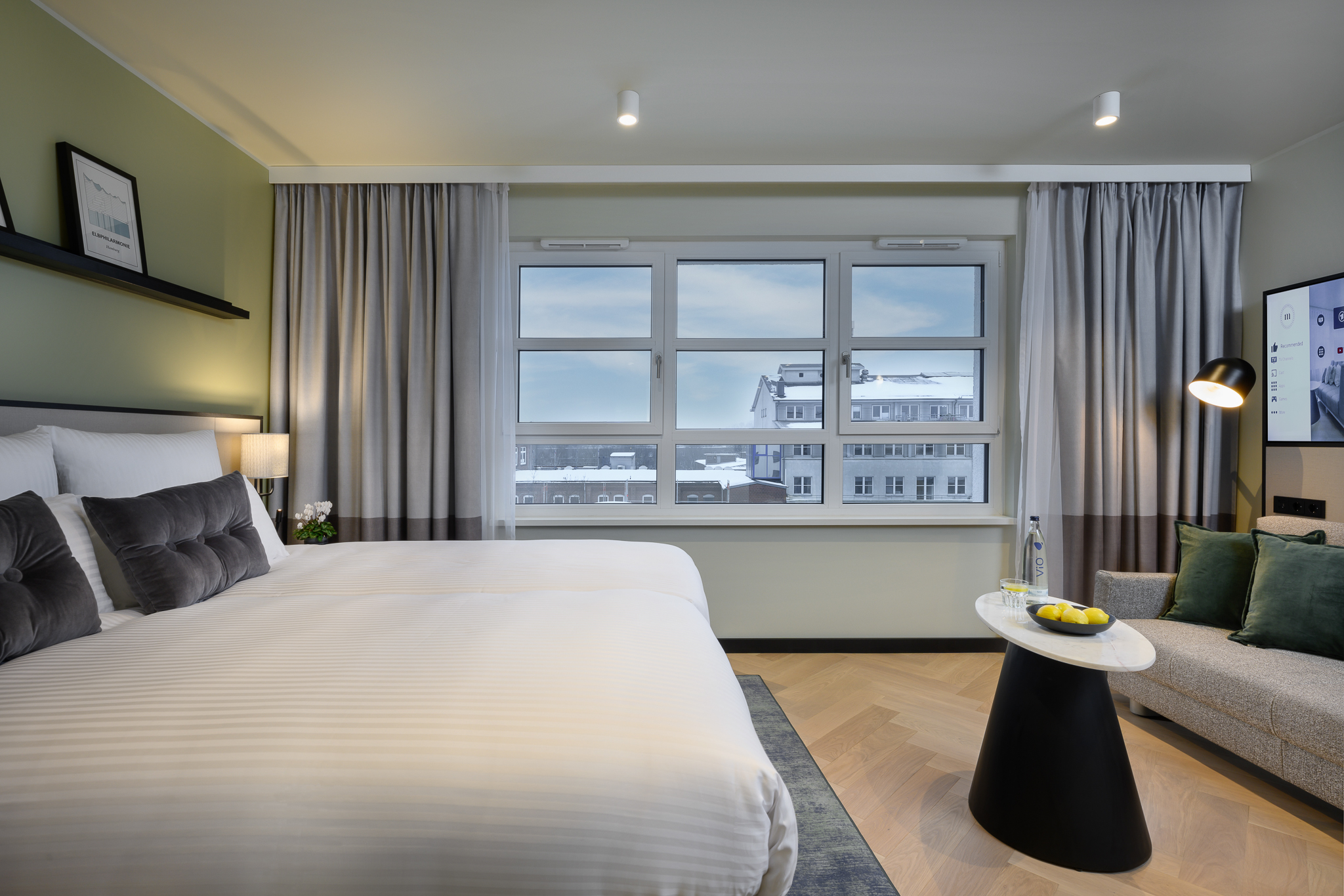 Inviting bed in the Studio with Sofa Bed at master Altona Hamburg, positioned by a window that fills the space with natural light.