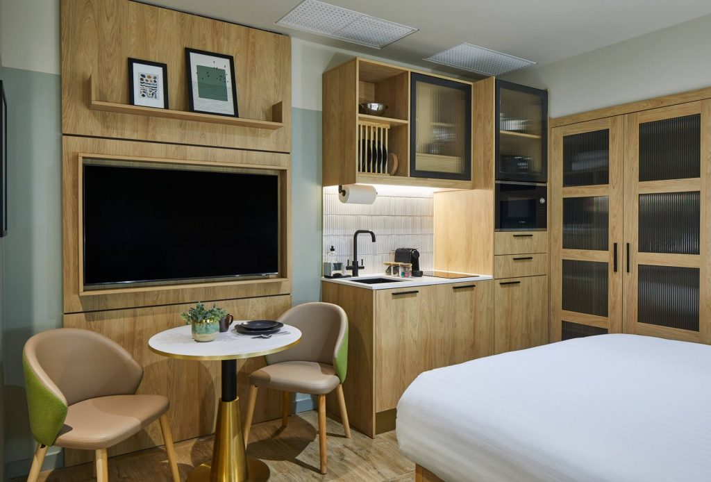 Compact and stylish Inner Lightwell Studio at master St. Paul’s London, featuring a cozy bed and a functional kitchenette for convenience.