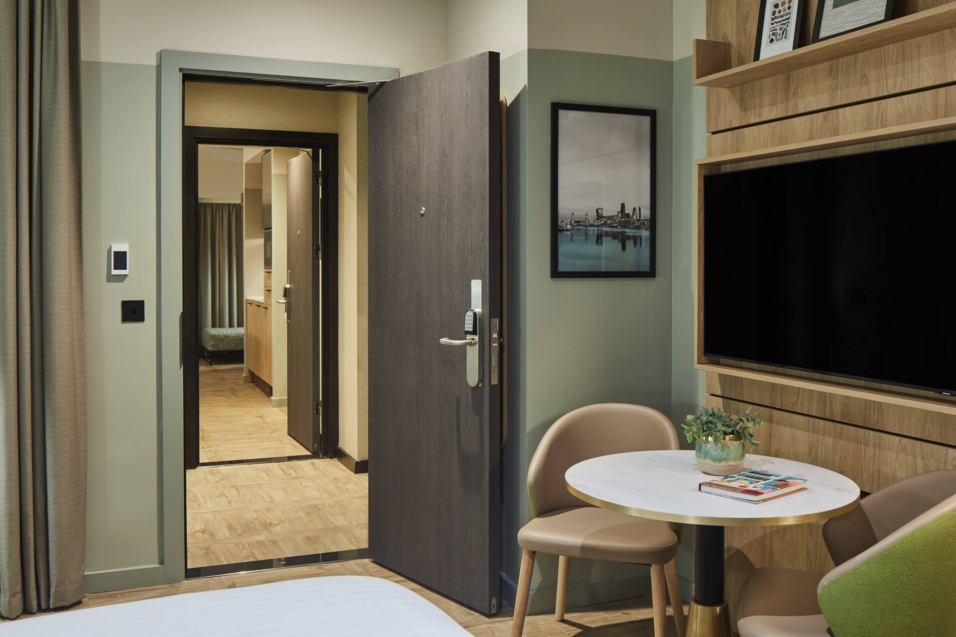 Bright and cozy bedroom in the Family Apartment at master St. Paul’s London, featuring a comfortable bed and an open connecting door
