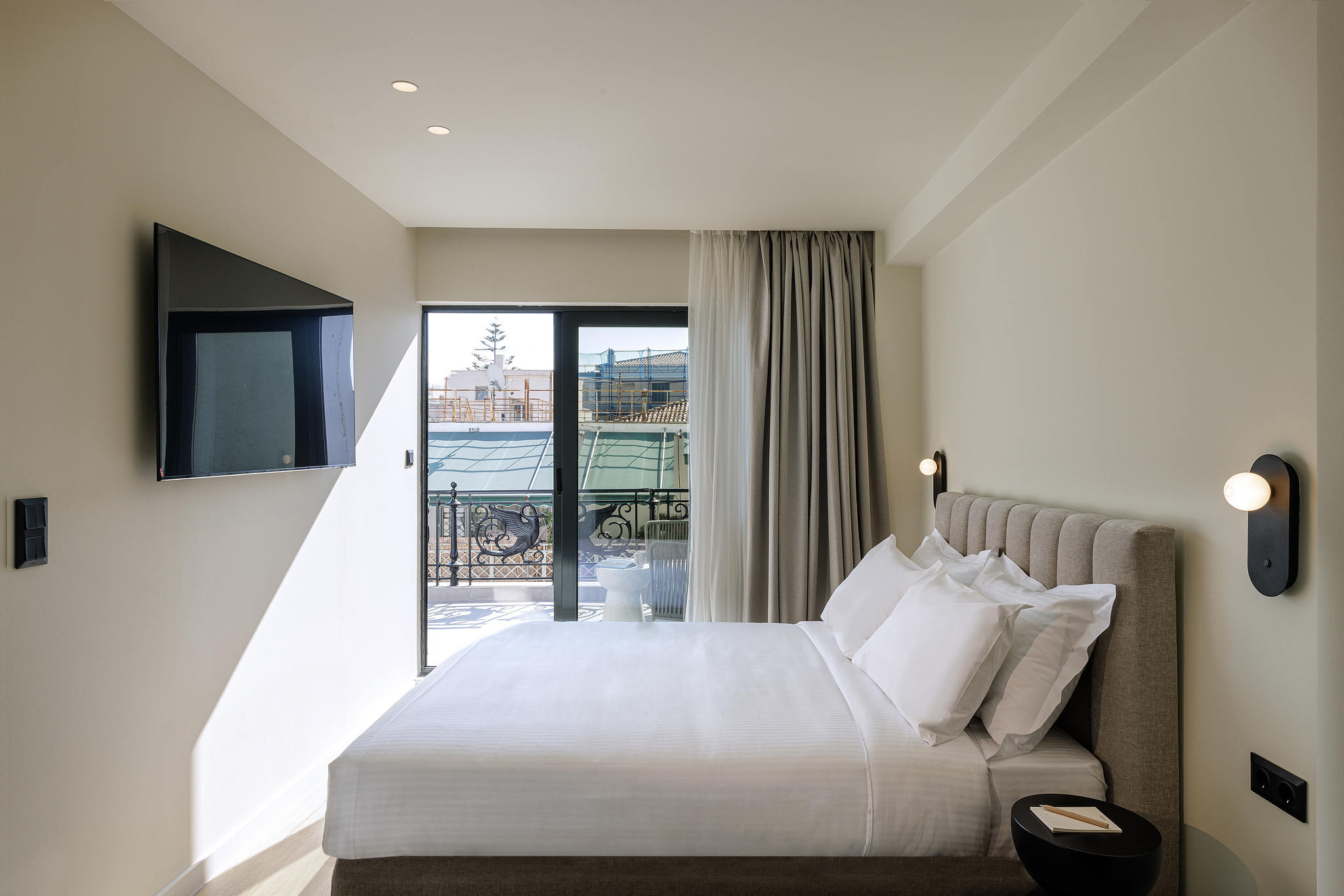 Bright and airy studio at master Plaka Athens, featuring a cozy bed and a balcony that fills the space with natural light.