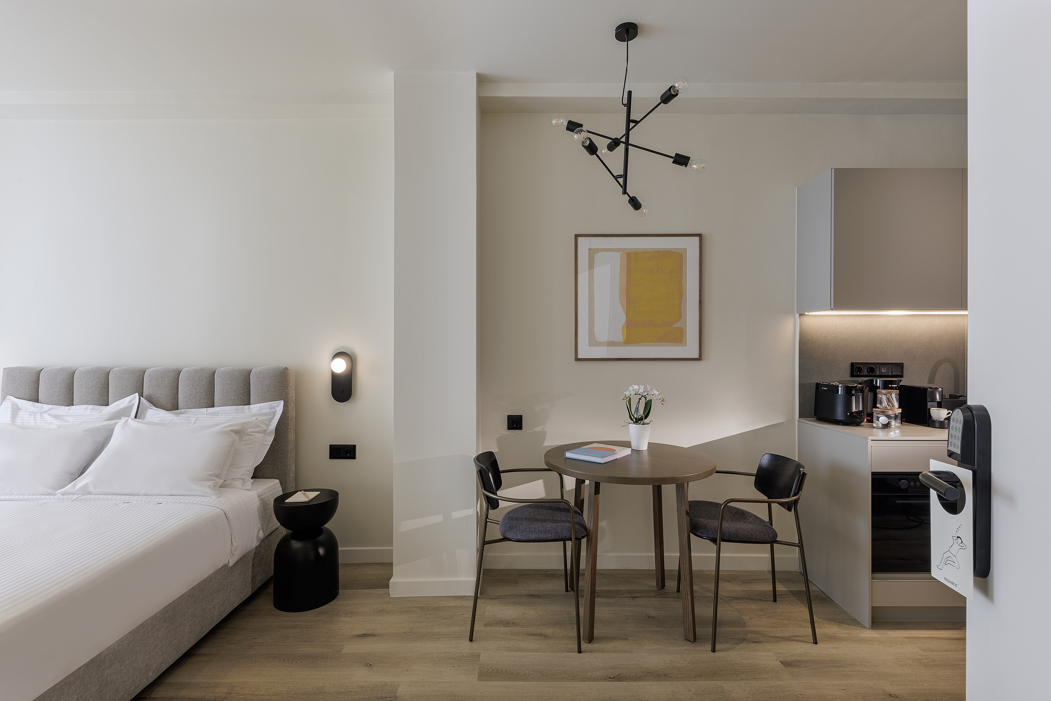 Bright and well-designed Studio Apartment at master Plaka Athens, featuring a plush bed and contemporary furnishings.