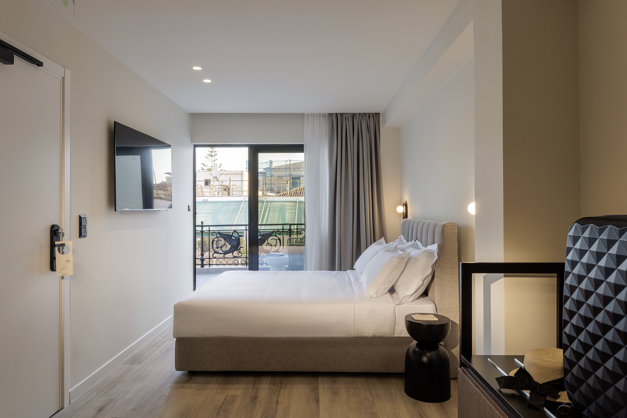 Well-designed Studio with Balcony at master Plaka Athens, where the bed faces an inviting outdoor space with scenic views.