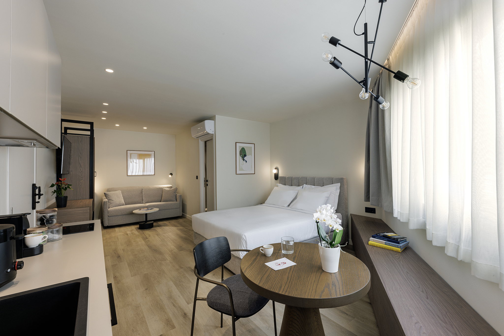 Cozy sleeping area in the Family Apartment at master Plaka Athens, blending modern design with soft, neutral tones.