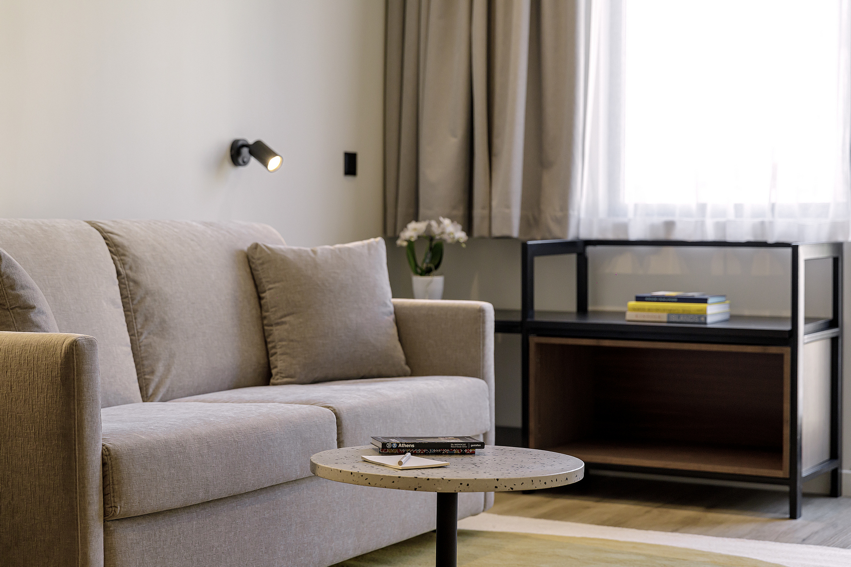 Bright and inviting living space in the One Bedroom Apartment with Balcony at master Plaka Athens, designed with a comfortable sofa for relaxation.