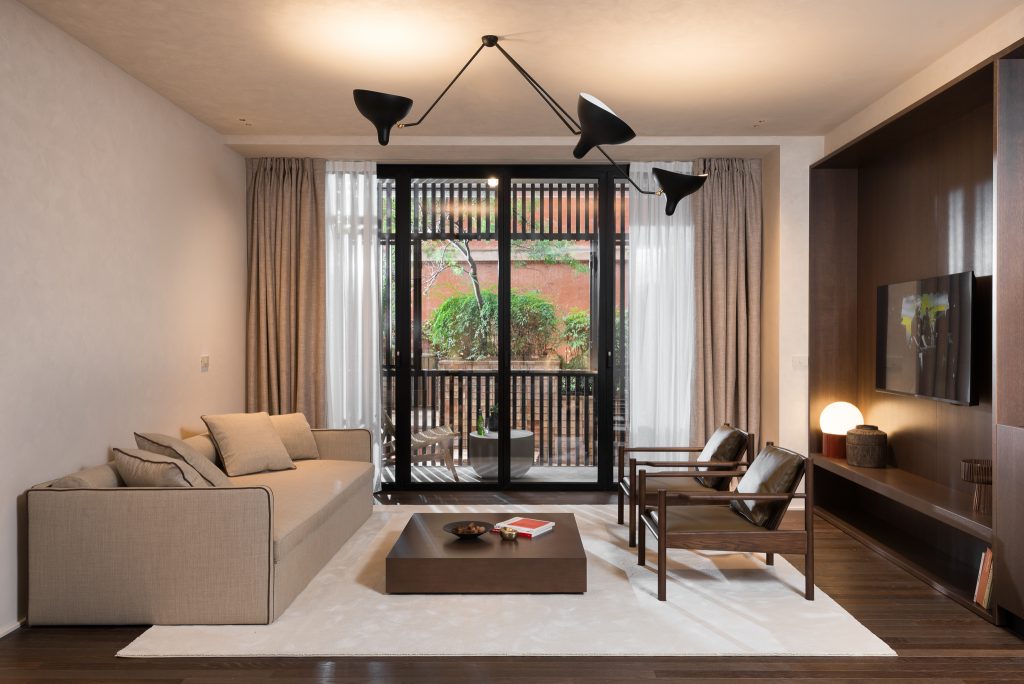 Modern and inviting living area in the Large Studio Ground Level at master Trevi Rome, offering a relaxing atmosphere with views outside.