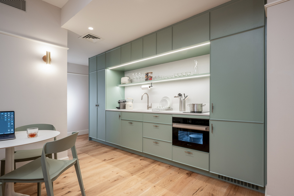 Modern kitchen in the One-Bedroom with Sofa Bed at master Mazeh Tel Aviv, equipped with sleek appliances and a functional layout.