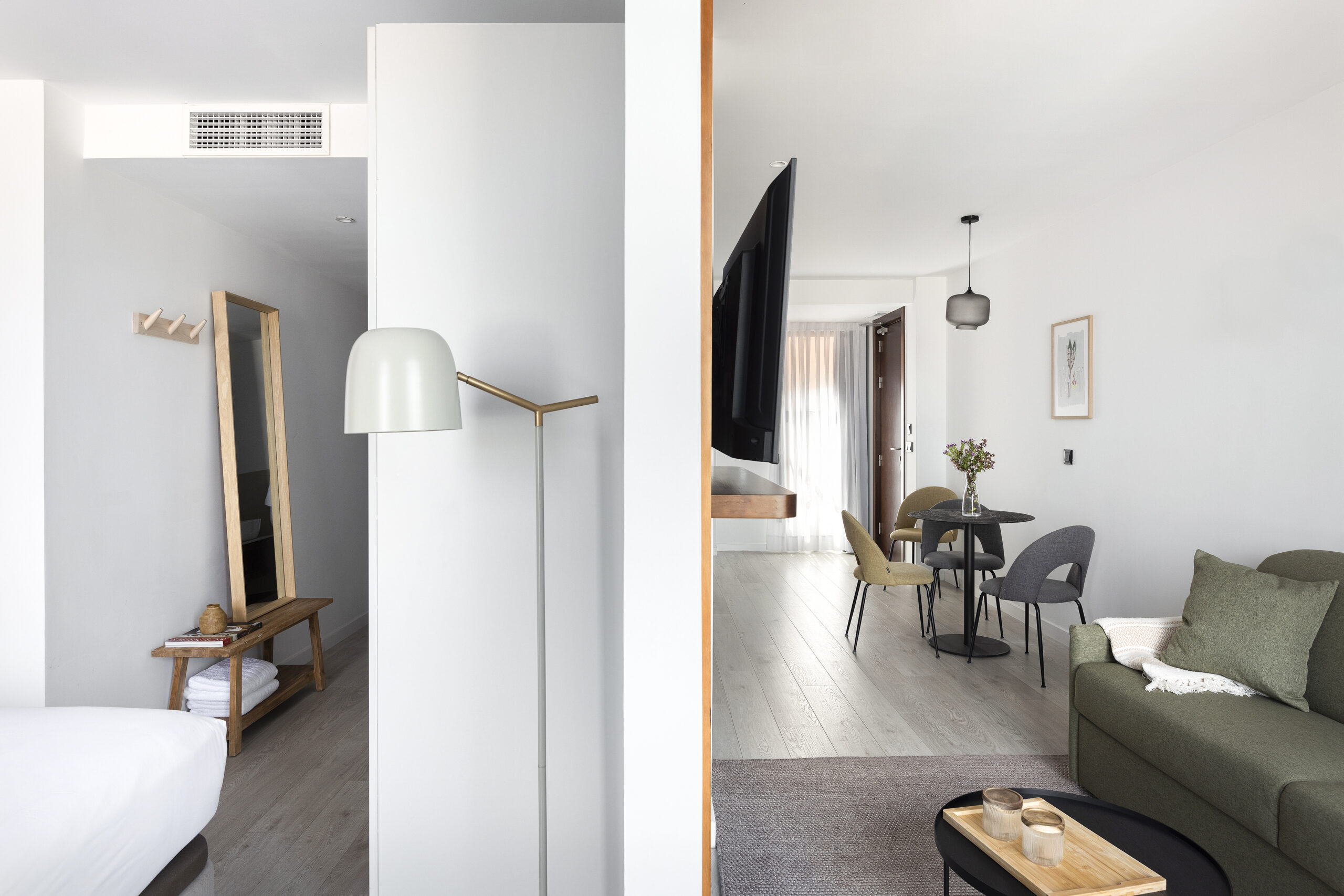 Two Bedroom Apartment at master La Rambla Barcelona showing bedroom, hallway, and open dining area with contemporary furniture.