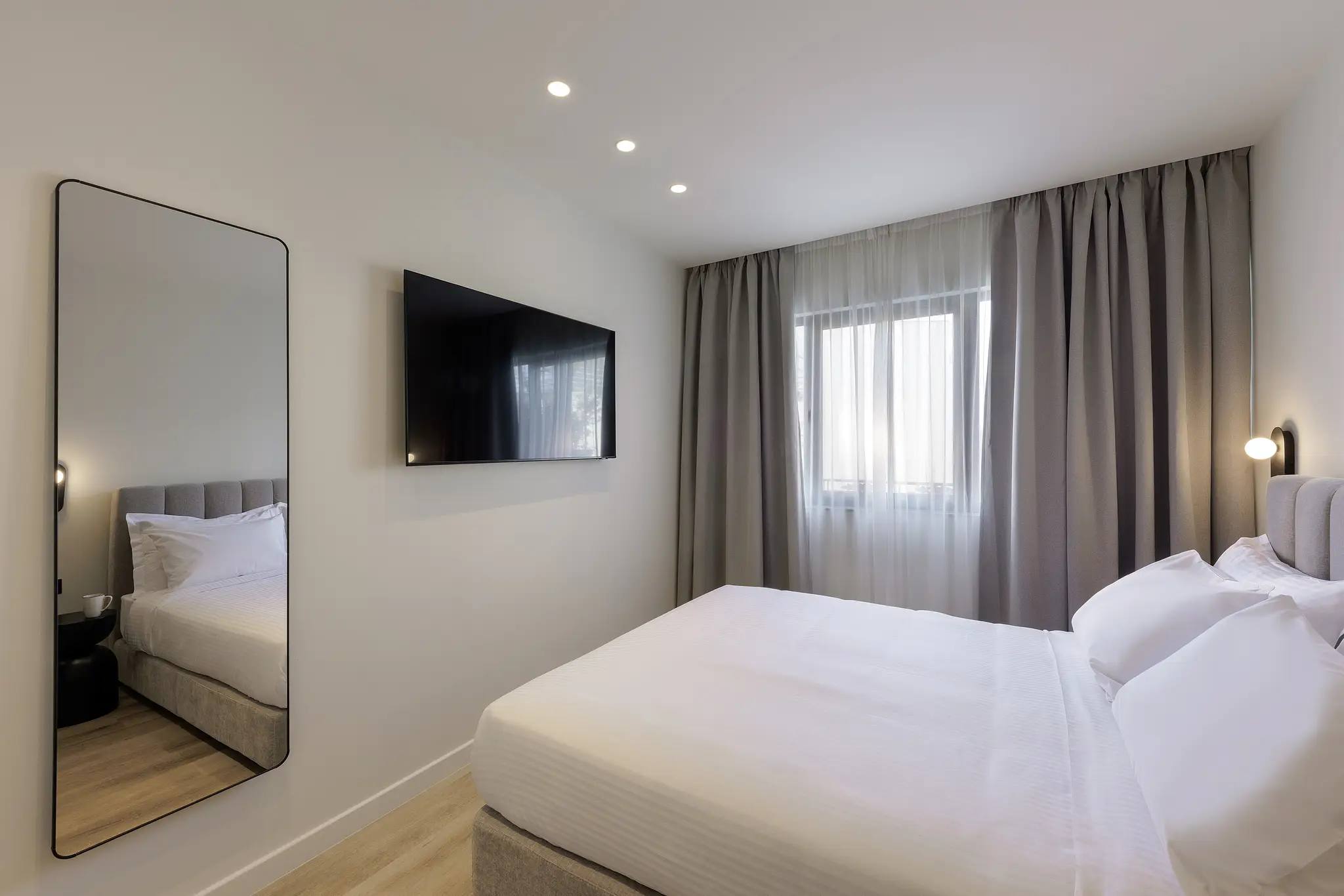 Chic and cozy sleeping area in the One Bedroom Apartment with Balcony at master Plaka Athens, designed for a restful stay with soft lighting and elegant decor.