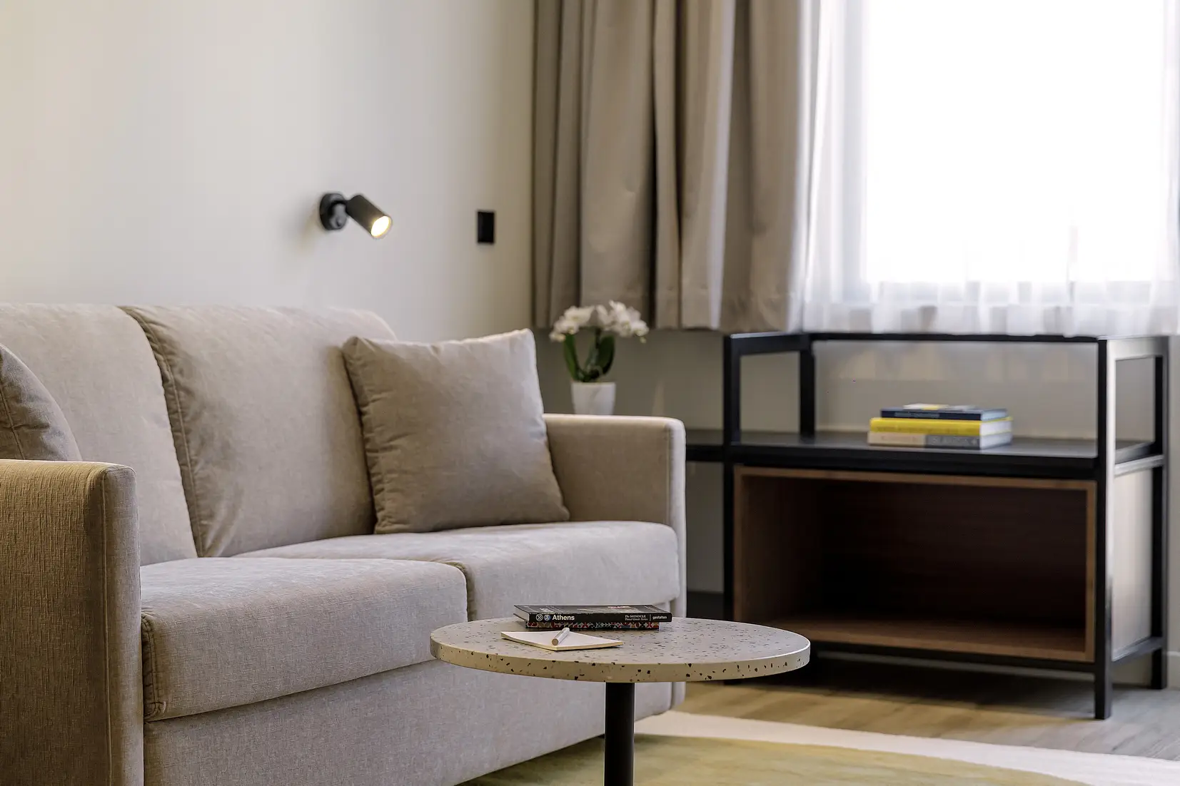 Bright and inviting living space in the One Bedroom Apartment with Balcony at master Plaka Athens, designed with a comfortable sofa for relaxation.