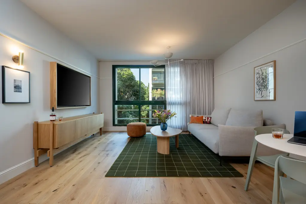 Spacious and inviting living area in the One-Bedroom with Sofa Bed at master Mazeh Tel Aviv, featuring a cozy sofa and modern furnishings.
