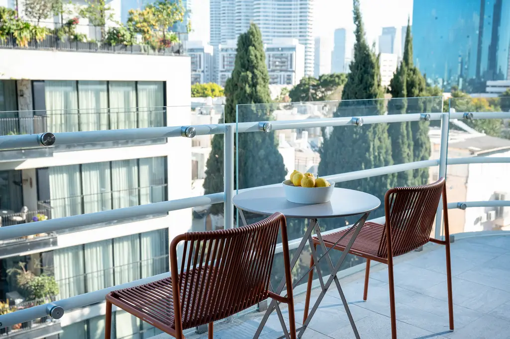 Private balcony in the One-Bedroom with Balcony at master Mazeh Tel Aviv, offering a peaceful outdoor space to relax.